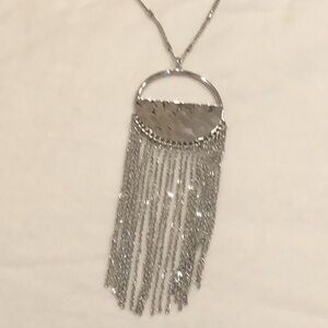 Chico’s long silver necklace with hammered silver pendant with tassels